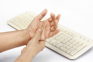 Senior woman painful finger due to prolonged use of keyboard clipart