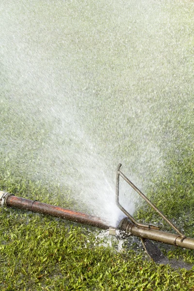 Wasting water - water leaking from a connector of pipe — Stock Photo, Image