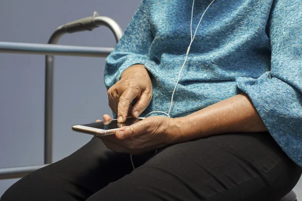 Elderly woman using mobile phone.