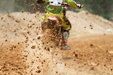 Mud debris flying from a motocross race clipart