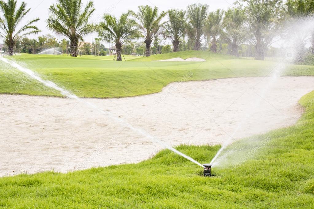 Sprinkler watering golf course.