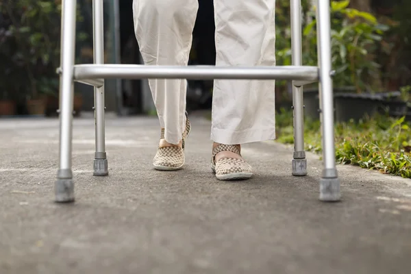 Senior woman using a walker at home. — Stock Photo, Image