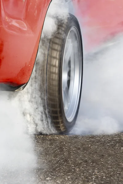 Race car burns rubber off its tires in preparation for the race — Zdjęcie stockowe