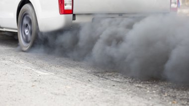 Air pollution from vehicle exhaust pipe on road clipart