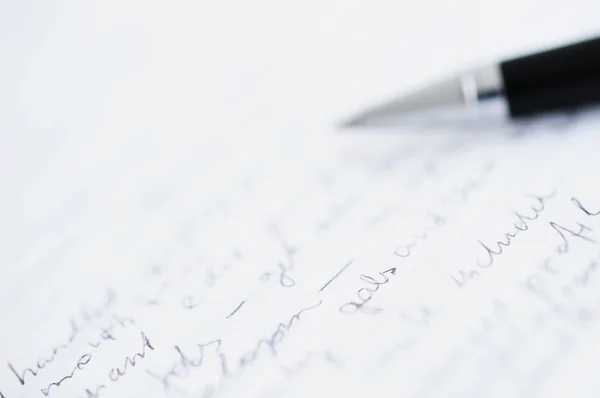 Shallow DOF photo of white paper and pen — Stock Photo, Image