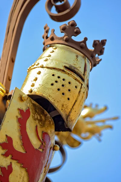 Attributes of knights decorating medieval fountain in historical center of Hague — Stock Photo, Image