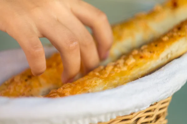 Children takes cheese sticks bread in cafe — Stock Photo, Image