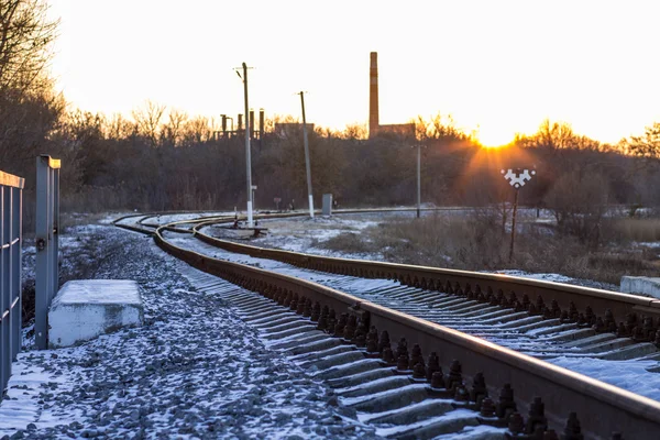 Zonsondergang in de winter op spoorweg in platteland — Stockfoto
