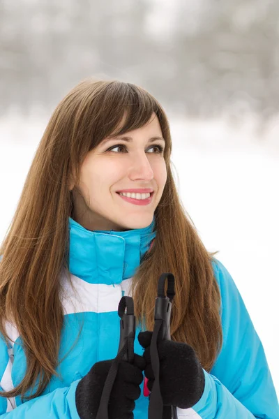 Young smiling woman skiing at the winter outdoor Stock Picture