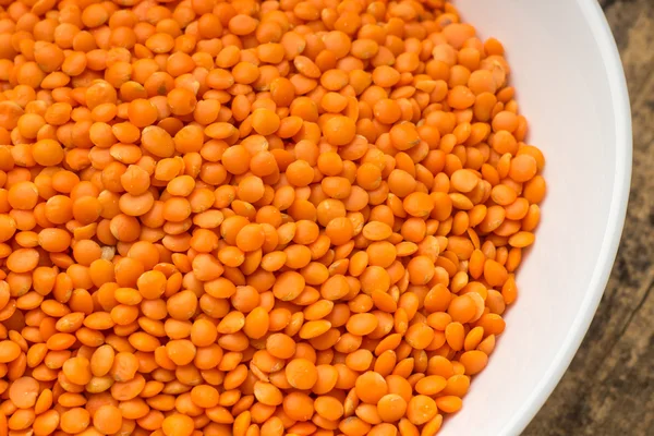 Raw lentil in bowl — Stock Photo, Image