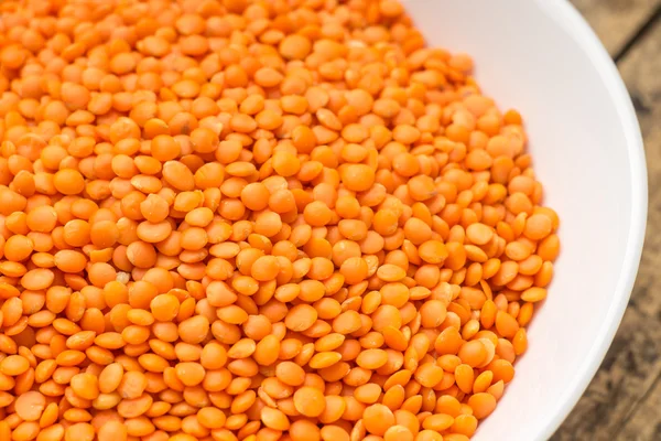 Raw lentil in bowl — Stock Photo, Image