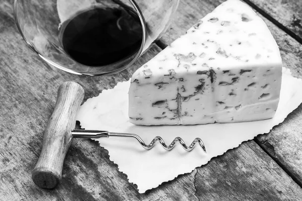 Cheese with mold, corkscrew and wineglass — Stock Photo, Image