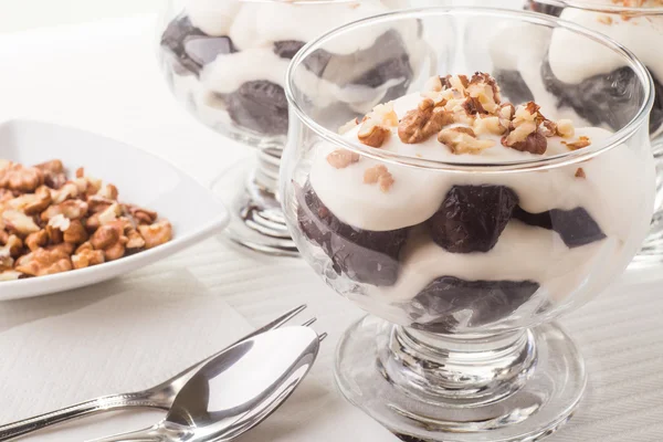 Десерт с черносливом, орехами и взбитыми сливками — стоковое фото