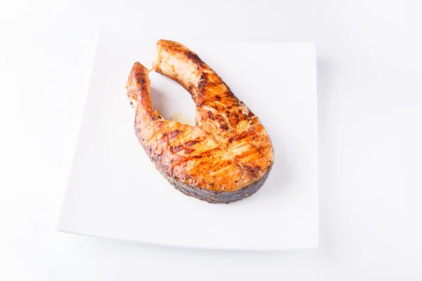 Grilled salmon steak isolated on white plate — Stock Photo, Image