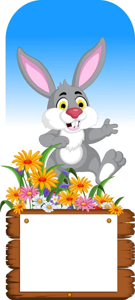 Dibujos animados de conejo posando con signo en blanco — Vector de stock