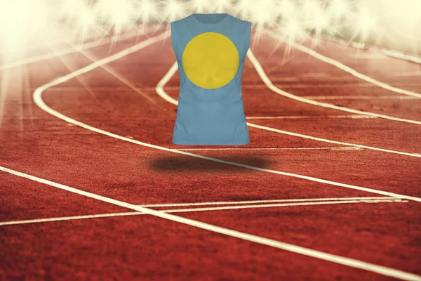 Red running track with lines and Palau flag on shirt — Stock Photo, Image