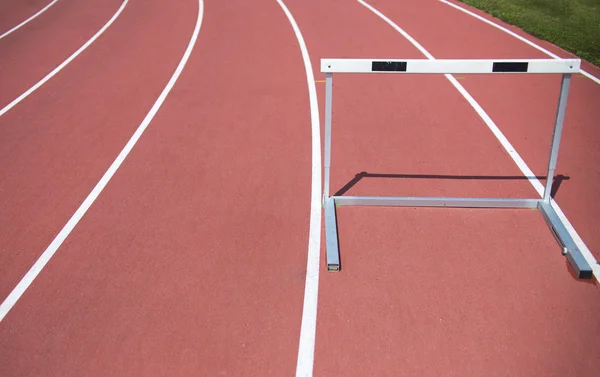 Red race track and hurdle in athletic lines — Stock Photo, Image