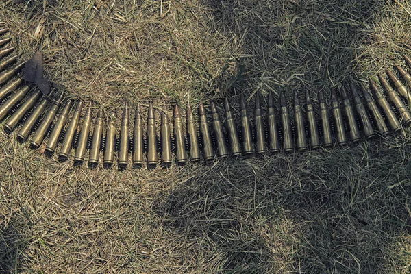 Ammo to machine guns on grass, HDR — Stock Photo, Image