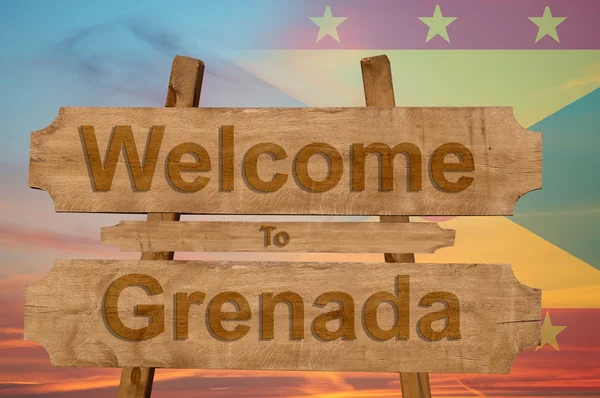 Välkommen till Grenada sjunga på trä bakgrund med blandning flagga — Stockfoto