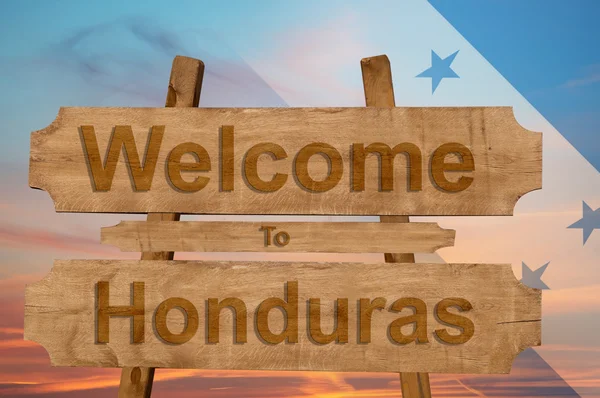 Benvenuti in Honduras cantare su sfondo di legno con miscelazione bandiera nazionale — Foto Stock