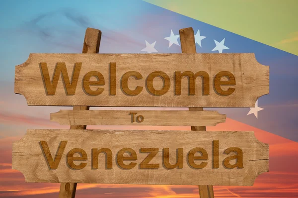 Bienvenidos a Venezuela cantan sobre fondo de madera mezclando bandera nacional — Foto de Stock