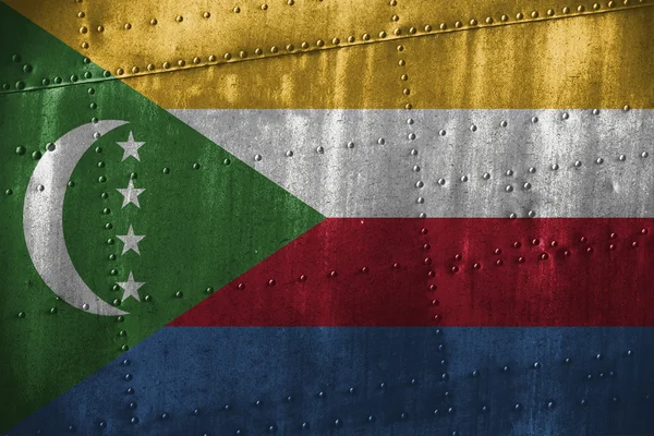 Texutre de metal o fondo con bandera de Comoras — Foto de Stock