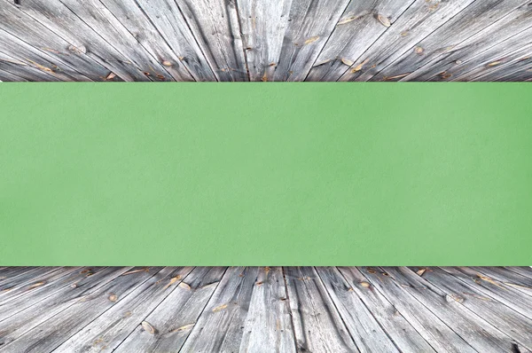 Green Paper on wood background or texture — Stock Photo, Image