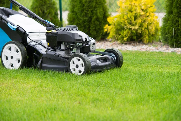 Lawn mower in the garden. — Stock Photo, Image