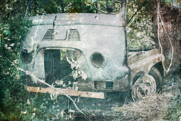 Old Car rusting in forest, demage color vintage photo effect