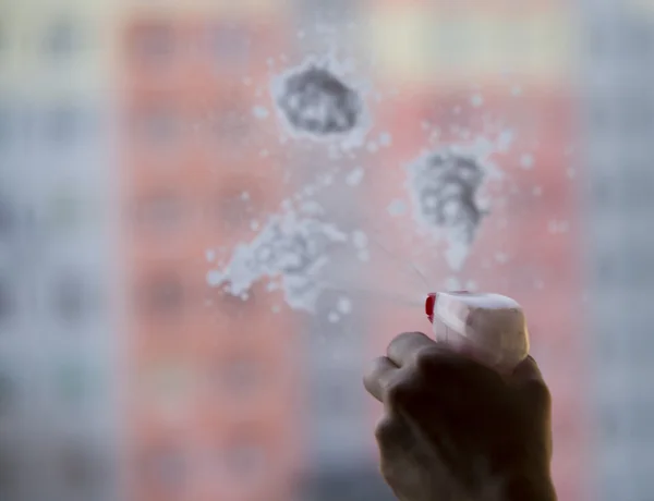 Young woman washing windows — Stock Photo, Image