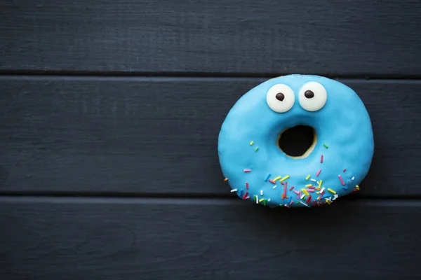 Donut on wooden background — Stock Photo, Image