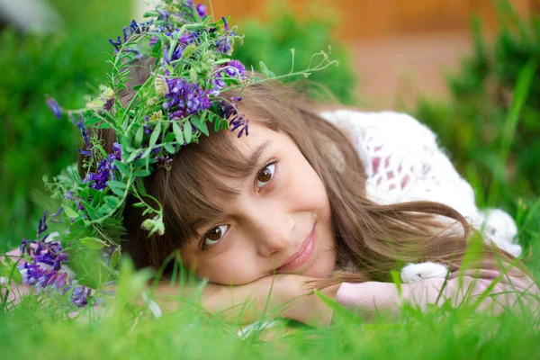 Ребенок с цветами, на зеленой траве — стоковое фото