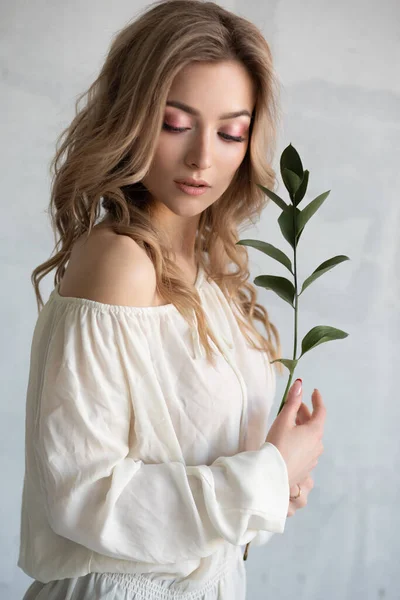 Una joven hermosa mujer con una flor en las manos. Retrato de moda de cerca —  Fotos de Stock