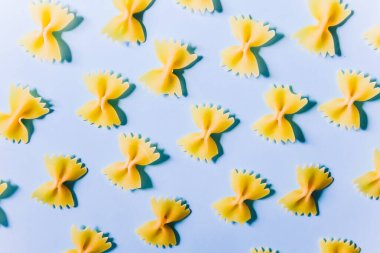 Mavi arka planda kelebek makarnası. tam tahıl