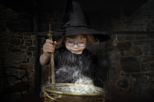 Little witch preparing a potion — Stock Photo, Image