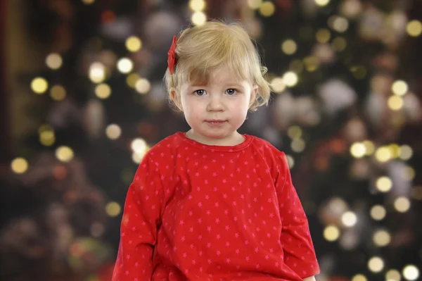 Μικρό μικρό παιδί μπροστά από ένα χριστουγεννιάτικο δέντρο — Φωτογραφία Αρχείου