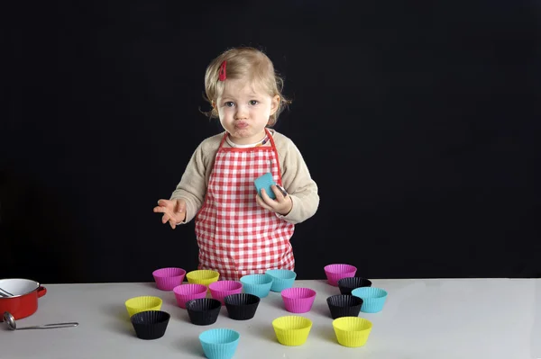 Little toddler making cupcakes, — Stock Photo, Image