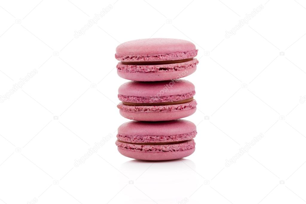 Three red colored macaroons isolated