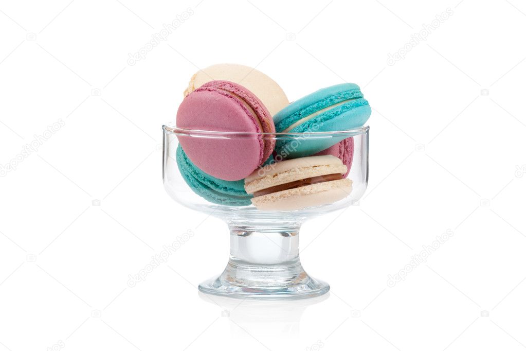 Colorful macaroons in a glass vase isolated