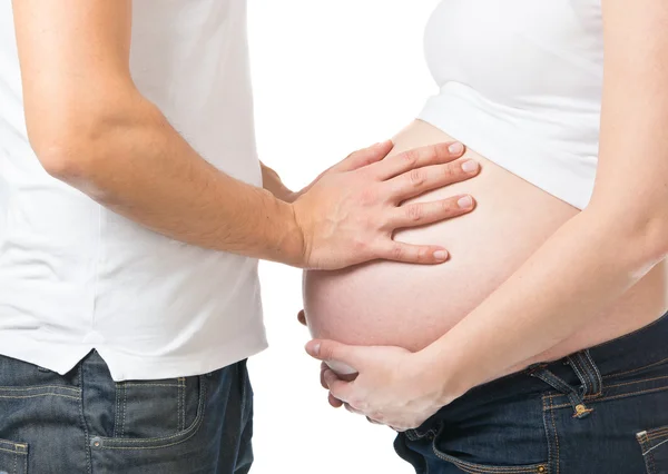 Pregnant woman and man holding hands on abdomen — Stock Photo, Image