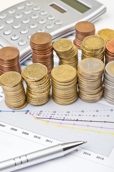 Monedas, calculadora y pluma sobre tabla —  Fotos de Stock