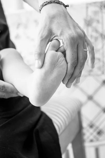 Woman Hand Holds Small Foot Baby — Stock Photo, Image