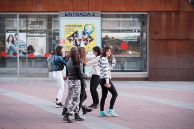 SORIA, İspanya - 6 Eylül 2019: Ergen kızlar şehir sokaklarından birinde yürürken eğleniyorlar.