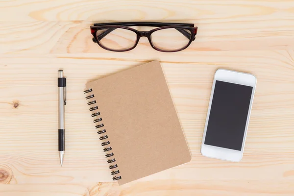 Notebook and mobile phone on wood background — Stock Photo, Image