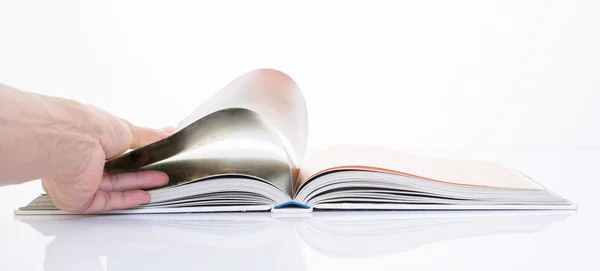 Hand opening the book on white background — Stock Photo, Image
