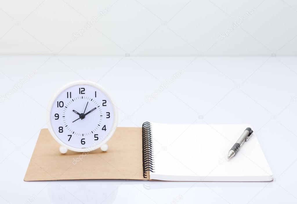 Notebook and office accessories on white background