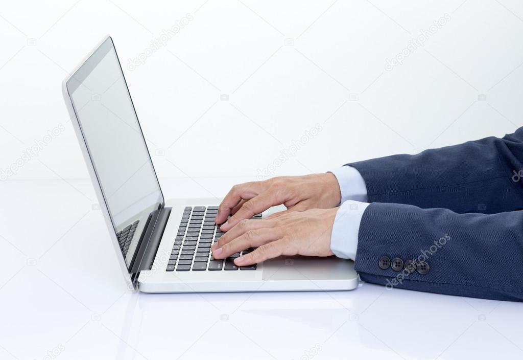 Businessman hands typing on keyboard laptop computer
