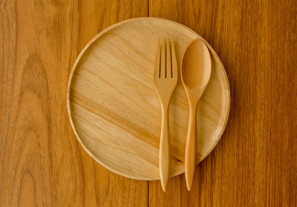 Wood plate fork spoon with window light from left side — Stock Photo, Image