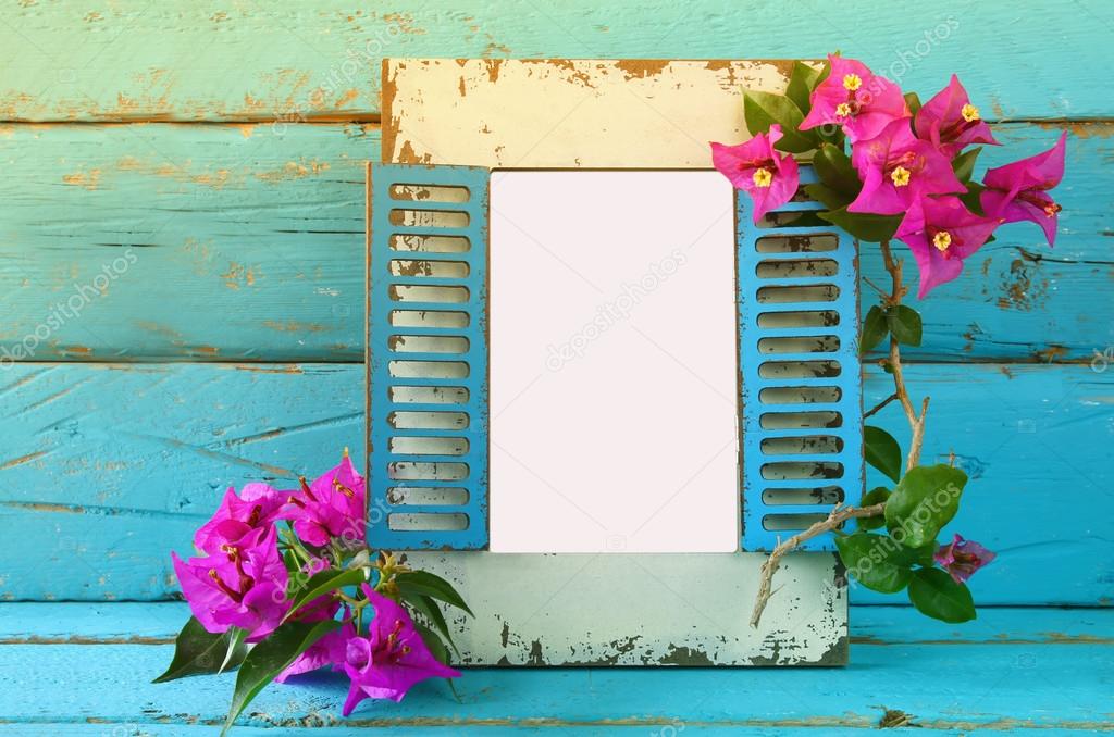 vintage blank frame next to beautiful purple mediterranean summer flowers. template, ready to put photography