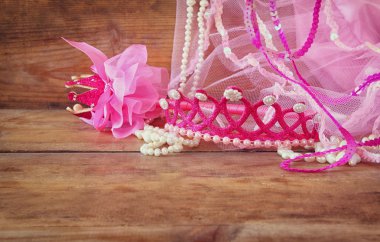 Small girls party outfit: crown and vail on wooden table. bridesmaid or fairy costume